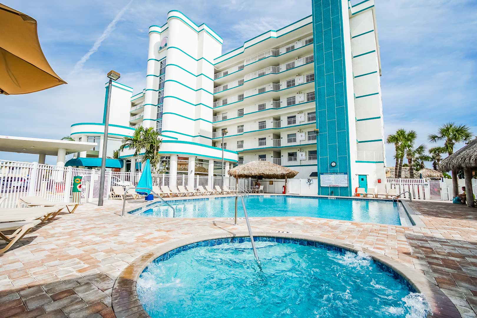 A crisp outdoor swimming pool and Jacuzzi at VRI's Discovery Beach Resort in Cocoa Beach, Florida.